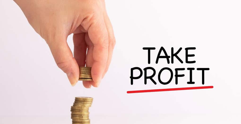  A hand is shown taking profit by moving a stack of coins from a bigger stack with the text 'Take Profit' below it.